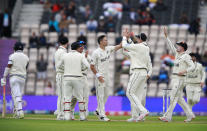 New Zealand's Trent Boult, center, celebrates with teammates the dismissal of India's Cheteshwar Pujara, left, during the second day of the World Test Championship final cricket match between New Zealand and India, at the Rose Bowl in Southampton, England, Saturday, June 19, 2021. (AP Photo/Ian Walton)