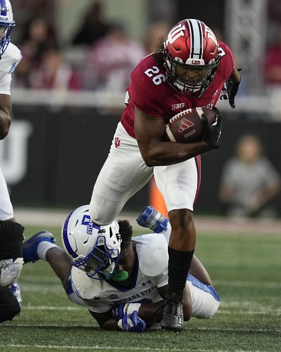 Indiana running back Josh Henderson (26) runs out of a tackle attempt by Indiana State linebacker Geoffrey Brown during the first half of an NCAA college football game Friday, Sept. 8, 2023, in Bloomington, Ind. (AP Photo/Darron Cummings)