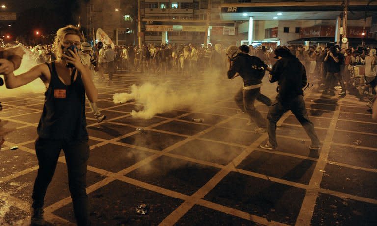 Protestors clash with riot squad officers on a street near Maracana stadium in Rio de Janeiro, Brazil on June 30, 2013. Protesters complain the government has found billions of dollars to build brand new stadiums for 12 World Cup host stadiums while transport, education and health remain underfunded