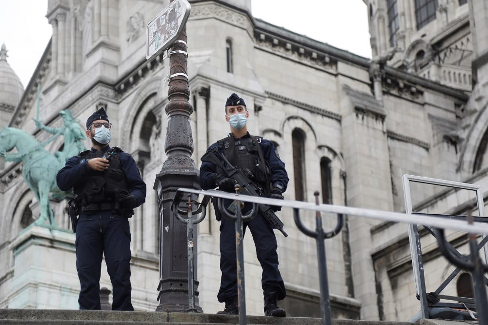 French CRS riot policemen stand guard in front of the Sacre-Coeur basilica of Montmartre in Paris as France has raised the security alert for French territory to the highest level after the knife attack in Nice October 30, 2020. — Reuters pic