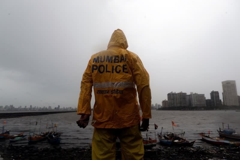 A Mumbai police official stands guard off the coast of the Arabic sea in Mumbai