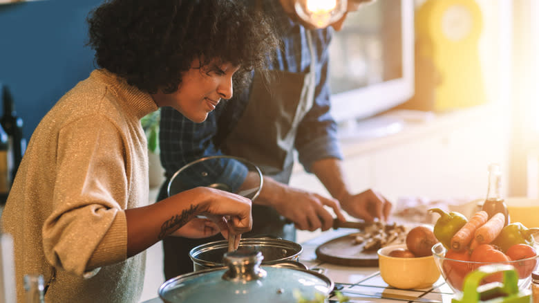 couple cooking together in kitchen