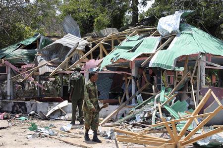 A Somali soldier stands in front of the destroyed Village Restaurant, the scene of a suicide car bombing, in Hamaerweyne district in Mogadishu September 7, 2013. A car bomb and suspected suicide bomber struck the restaurant in the Somali capital Mogadishu on Saturday, killing at least 15 people, police said. REUTERS/Feisal Omar