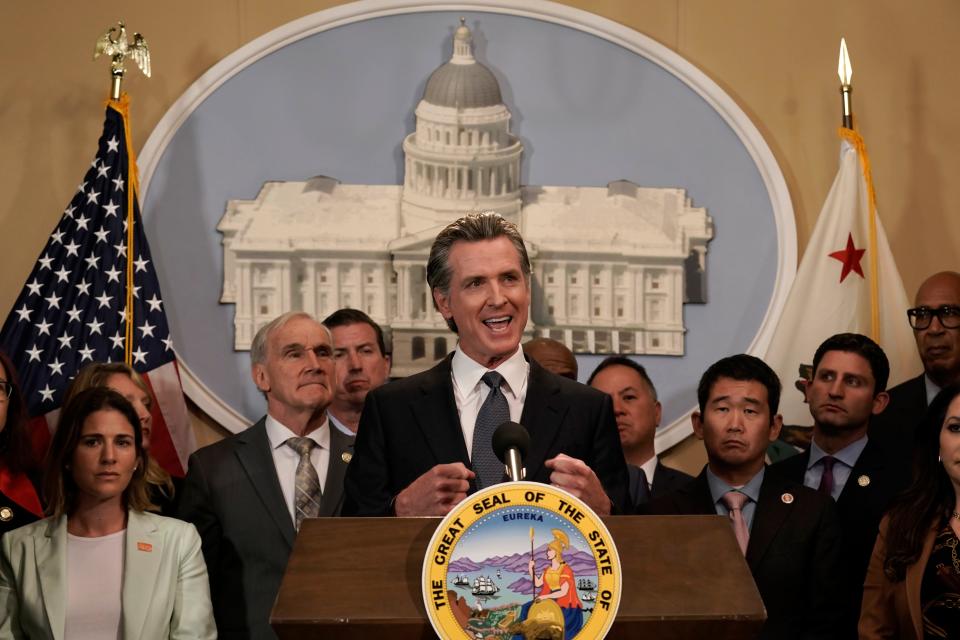 California Gov. Gavin Newsom discusses the recent mass shooting in Texas, during a news conference in Sacramento, Calif., Wednesday, May 25. Flanked by lawmakers from both houses of the state legislature, Newsom said he is ready to sign more restrictive gun measures passed by lawmakers.