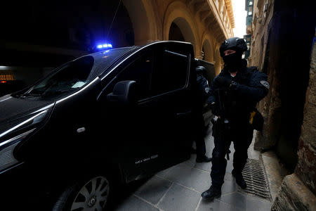 Armed police officers of the Malta Police Special Intervention Unit provide security as three men, accused of the assassination of anti-corruption journalist Daphne Caruana Galizia, arrive for their lawyers’ submissions for bail at the Courts of Justice in Valletta, Malta April 17, 2018. REUTERS/Darrin Zammit Lupi