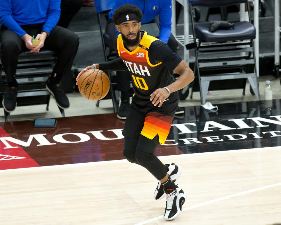 Jan 29, 2021; Salt Lake City, Utah, USA; Utah Jazz guard Mike Conley (10) dribbles the ball against the Dallas Mavericks during the first quarter at Vivint Smart Home Arena. 