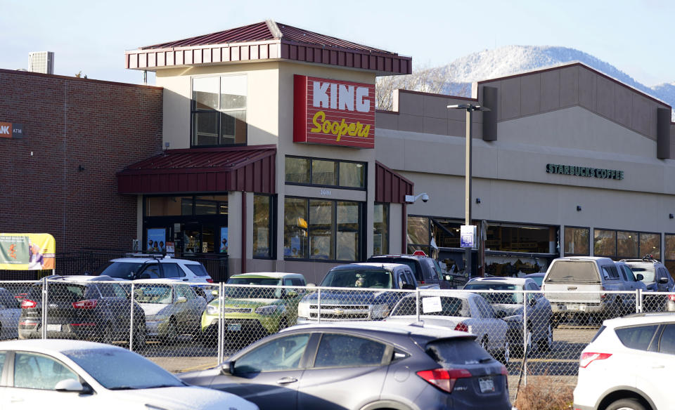 A makeshift fence stands around the parking lot outside a King Soopers grocery store where a mass shooting took place a day earlier in Boulder, Colo., Tuesday, March 23, 2021. (AP Photo/David Zalubowski)