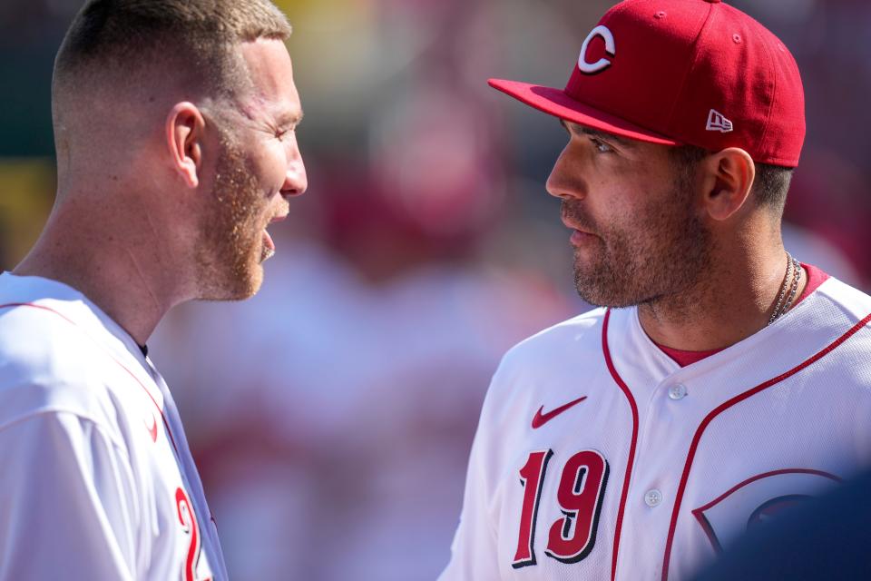 Former Reds third baseman Todd Frazier talks with Joey Votto before the first inning of the MLB Opening Day game between the Cincinnati Reds and the Pittsburgh Pirates at Great American Ball Park in downtown Cincinnati on Thursday, March 30, 2023. The Pirates led 4-2 in the fifth inning.