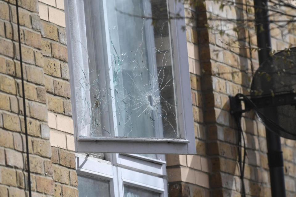 Shooting: a shattered window is seen at an address in Mandeville Street, Clapton (PA)