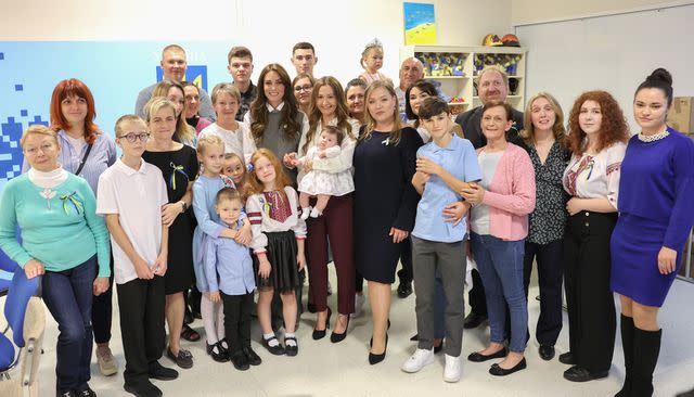 <p>Chris Jackson/Getty</p> Kate Middleton poses for a photo with staff, volunteers and Ukrainians at Vsi Razom Community Hub on Oct. 4