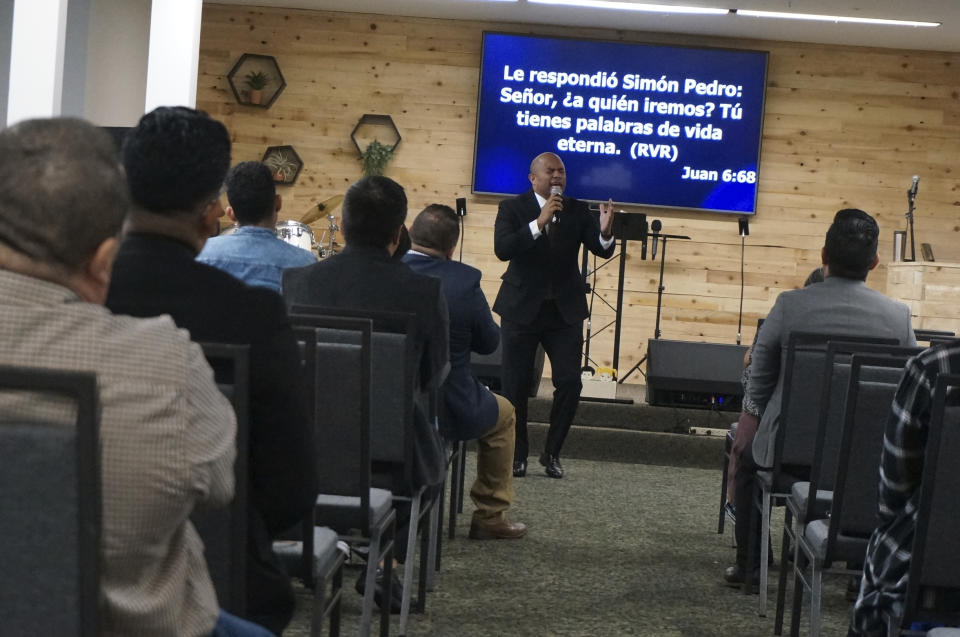 The Rev. Gustavo Castillo preaches to his congregation at the Iglesia Pentecostal Unida Latinoamericana in Columbia Heights, Minn., on Sunday, Sept. 24, 2023. The federal government recently moved thousands of green card applications for vulnerable minors from Central America in the queue for religious workers, leading to long delays and thus putting ministers on temporary work visas like Castillo at risk of losing the ability to stay in the United States. (AP Photo/Giovanna Dell'Orto)