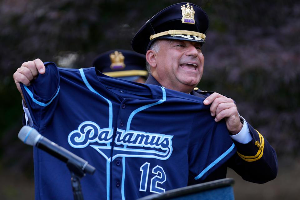 Robert M. Guidetti holds a jersey presented to him by his daughter, Nicole, after he became the 12th police chief of Paramus. Tuesday, June 13, 2023 