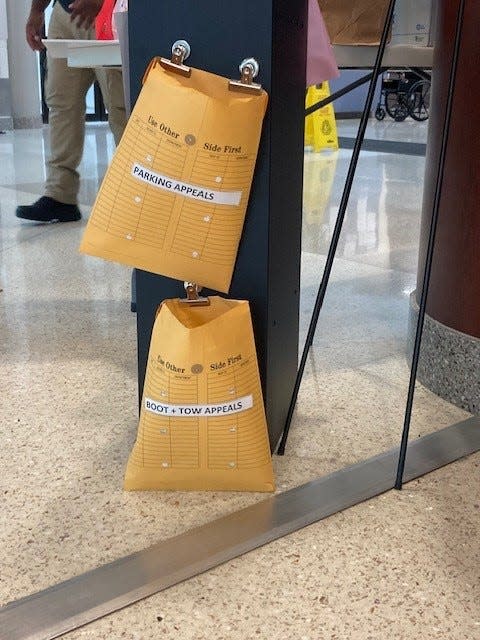 A stand is set up at Wilmington city offices for people to submit parking ticket, booting and towing appeals on Wednesday, July 19, 2023.