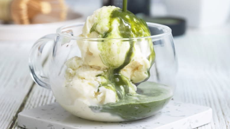 Pouring matcha over vanilla ice cream