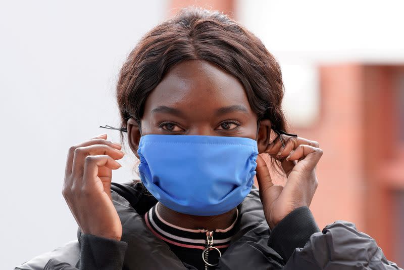 FILE PHOTO: A worker models a face mask made to help curb the spread of the coronavirus disease (COVID-19) in Melbourne