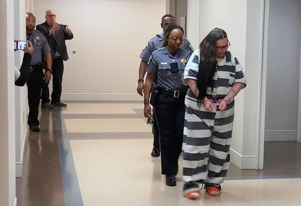 Kristy Marie Siple, center, is escorted to a courtroom Wednesday afternoon for a hearing before Circuit Court Judge David Johnson at the Russell County Courthouse in Phenix City, Alabama. 03/13/2024