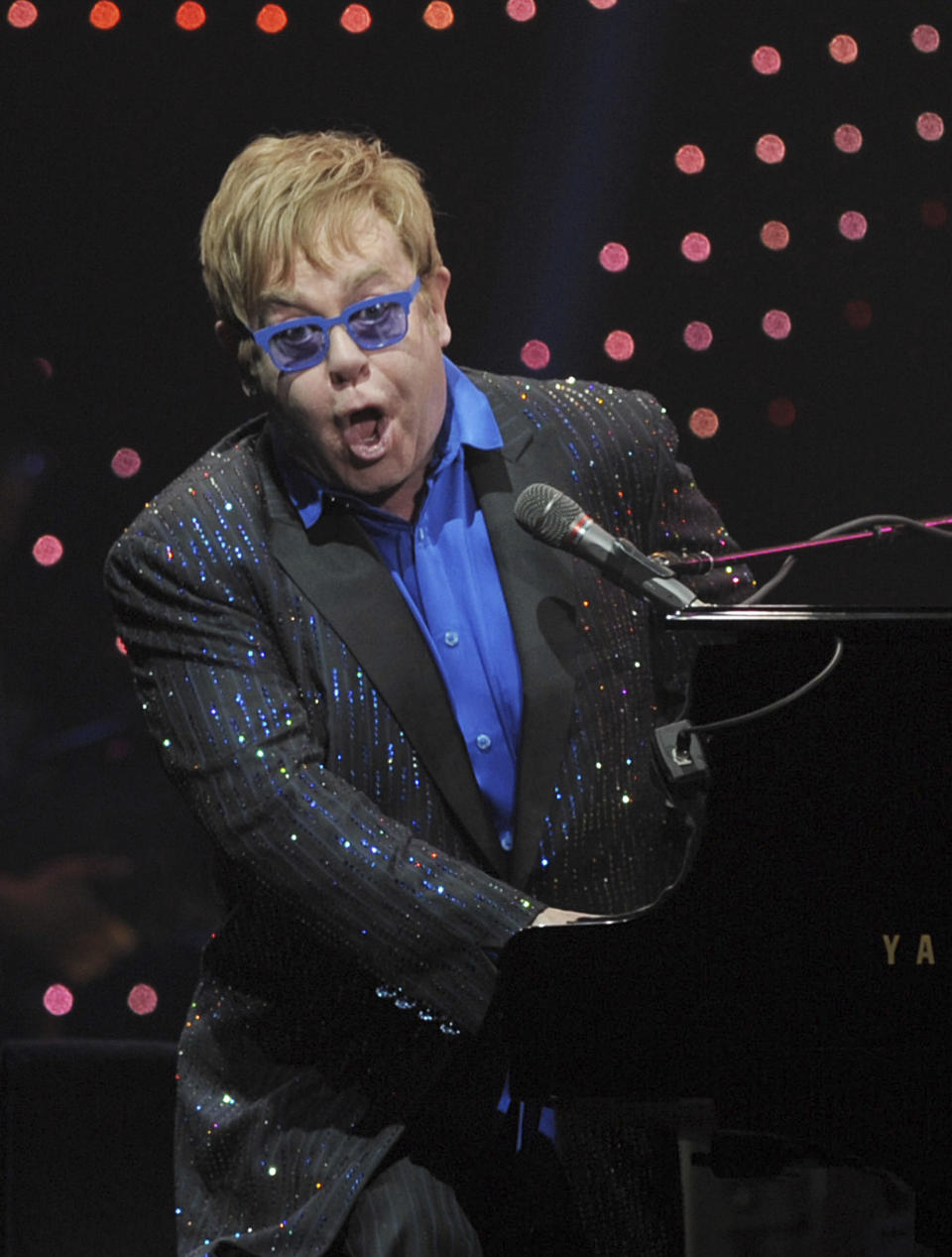 In this photo taken Sunday Nov. 25, 2012, pop icon Elton John performs during his concert in Beijing. John publicly dedicated his only concert in Beijing to Chinese artist and political critic Ai Weiwei, sending a murmur of shock through audience members accustomed to tight censorship of entertainment. (AP Photo) CHINA OUT