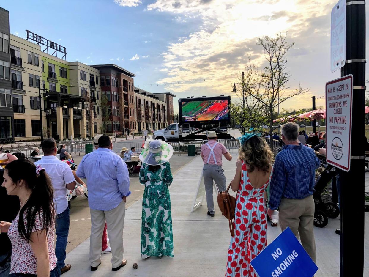 Patrons watch the Kentucky Derby at the Derby Day watch party in 2023 at the Ball Band Biergarten in Beutter Park. The city Parks and Recreation Department is sponsoring the May 4 Derby Day party for the 2024 race.