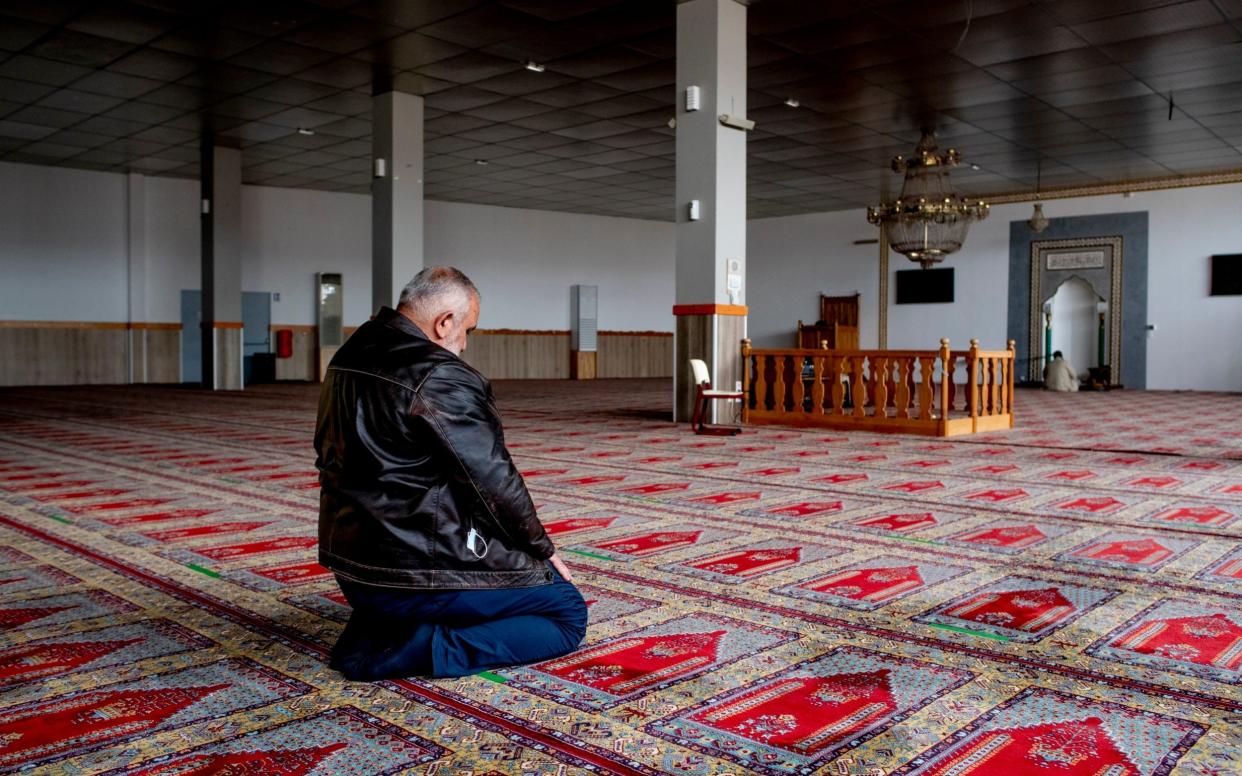 A worshipper in the temporary prayer room of Strasbourg Mosque - Bruno Fert