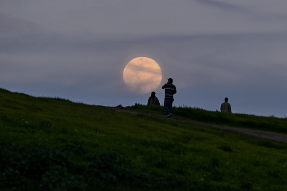 The Snow Moon seen through the haze by fisher men on Feb. 24 in San Mateo, california