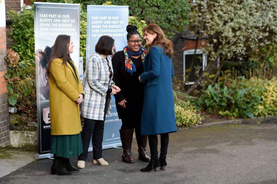 Kate is greeted by staff outside LEYF Stockwell Gardens Nursery and Pre-school