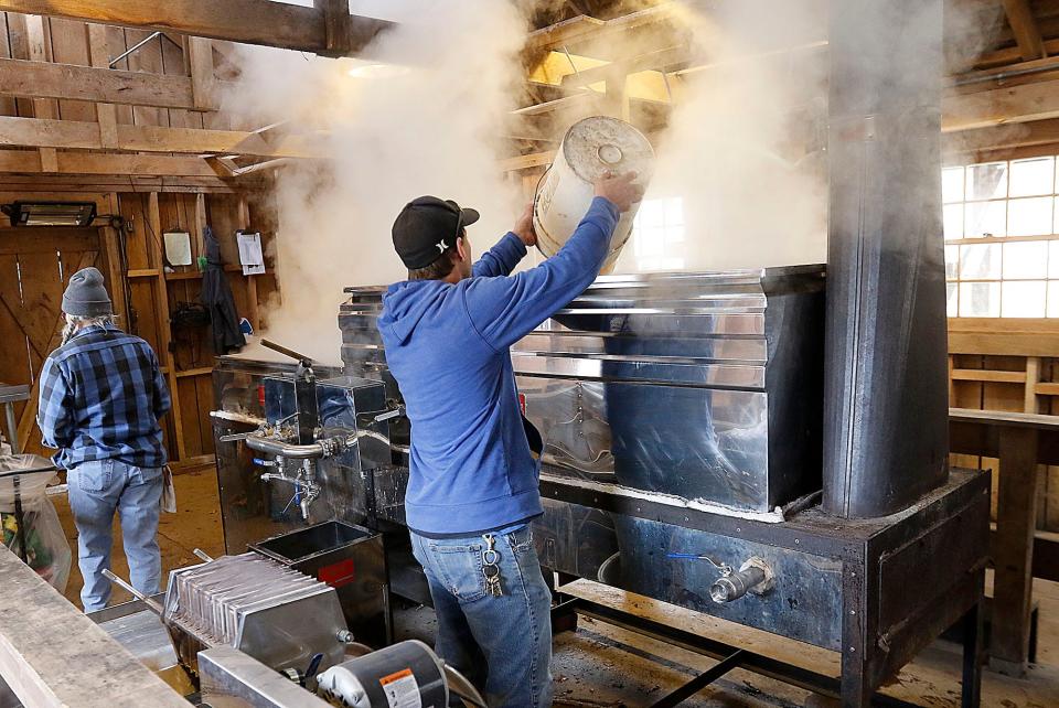 Kiristin Brubach and Jon Britton boil the sap from the maple trees to extract the maple syrup in the Malabar Farm Sugar Shack Tuesday, Feb. 21, 2023. TOM E. PUSKAR/ASHLAND TIMES-GAZETTE