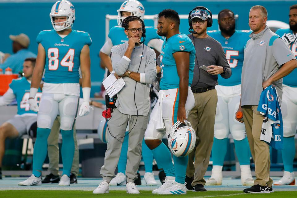 Aug 27, 2022; Miami Gardens, Florida, USA; Miami Dolphins head coach Mike McDaniel talks to quarterback Tua Tagovailoa (1) during the first quarter against the Philadelphia Eagles at Hard Rock Stadium. Mandatory Credit: Sam Navarro-USA TODAY Sports