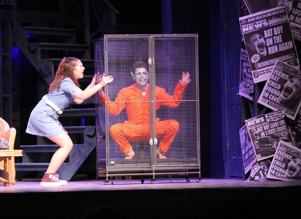 Shelley (Ava Pursel) begs Bat Boy (Liam Ginsburg) to stop squawking!  in Pelham Memorial High School's production of "Bat Boy: The Musical."