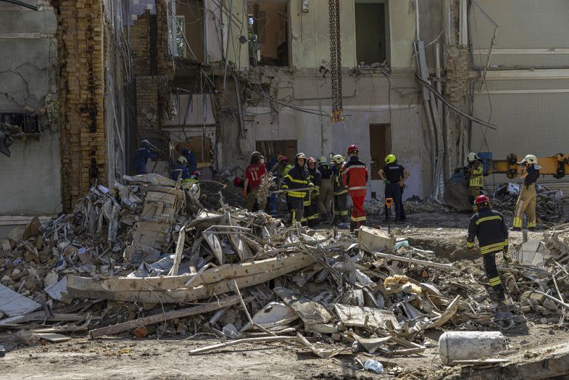 Rescue workers clear the rubble at the site of Okhmatdyt children's hospital hit by Russian missiles on Monday, in Kyiv, 9 July 2024