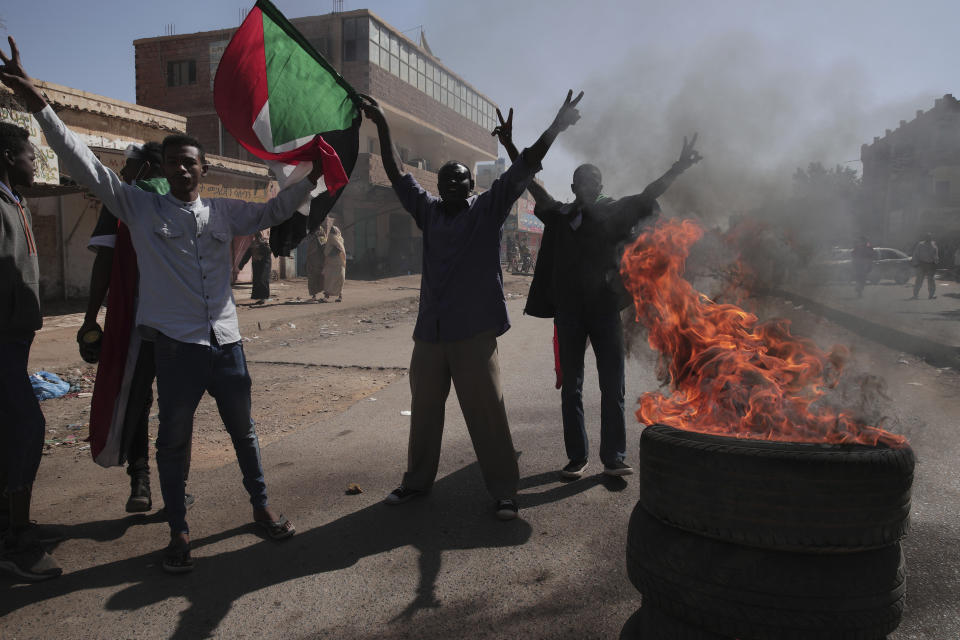 People chant slogans during a protest to denounce the October military coup, in Khartoum, Sudan, Thursday, Dec. 30, 2021. The October military takeover upended a fragile planned transition to democratic rule and led to relentless street demonstrations across Sudan. (AP Photo/Marwan Ali)