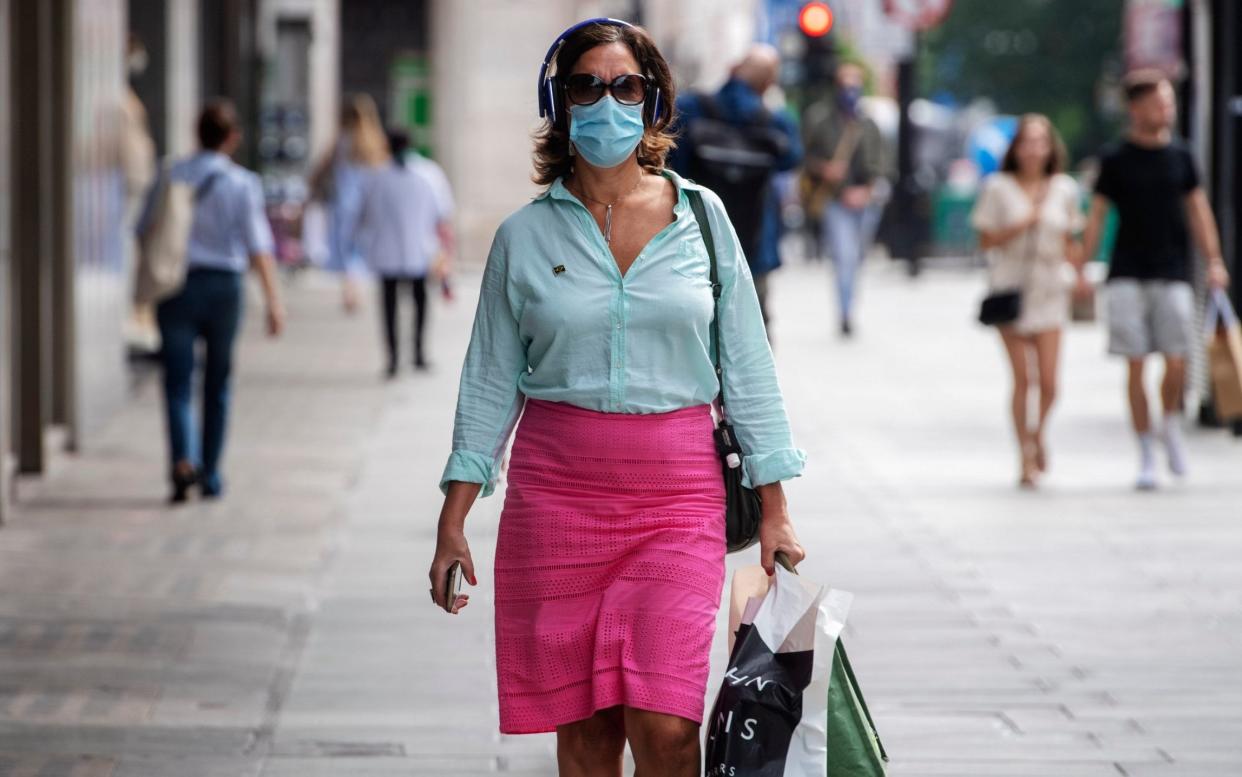 A shopper wearing a mask in London ahead of the rules being implemented - Paul Grover for the Telegraph 
