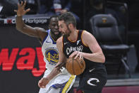 Cleveland Cavaliers' Kevin Love, right, drives against Golden State Warriors' Draymond Green (23) in the second half of an NBA basketball game, Thursday, April 15, 2021, in Cleveland. (AP Photo/David Dermer)