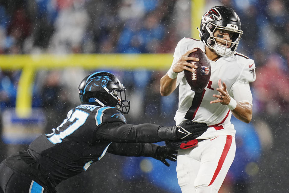 Atlanta Falcons quarterback Marcus Mariota passes under pressure from Carolina Panthers defensive end Yetur Gross-Matos during the second half of an NFL football game on Thursday, Nov. 10, 2022, in Charlotte, N.C. (AP Photo/Rusty Jones)