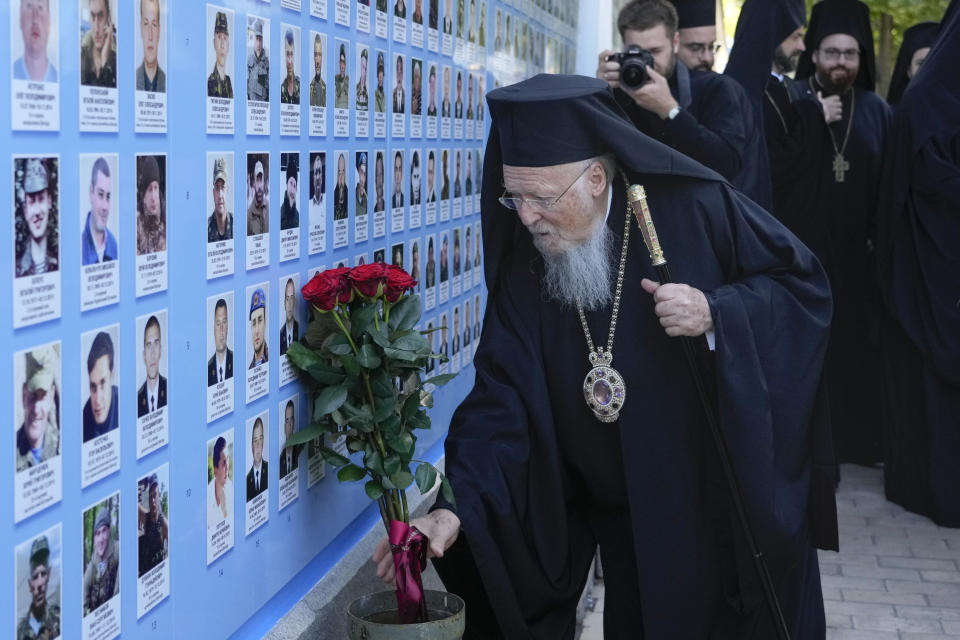 Ecumenical Patriarch Bartholomew I lays flowers at the Memorial Wall of Fallen Defenders of Ukraine in Russian-Ukrainian War in Kyiv, Ukraine, Saturday, Aug. 21, 2021. Bartholomew I, arrived to Kyiv to mark the 30th anniversary of Ukraine's independence that is celebrated on Aug. 24. (AP Photo/Efrem Lukatsky)