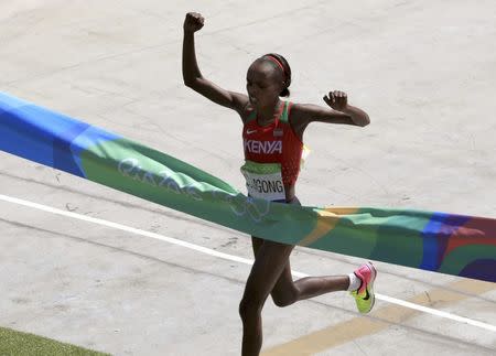 2016 Rio Olympics - Athletics - Final - Women's Marathon -Sambodromo - Rio de Janeiro, Brazil - 14/08/2016. Jemima Sumgong (KEN) of Kenya crosses the finish line to win the race REUTERS/Dominic Ebenbichler