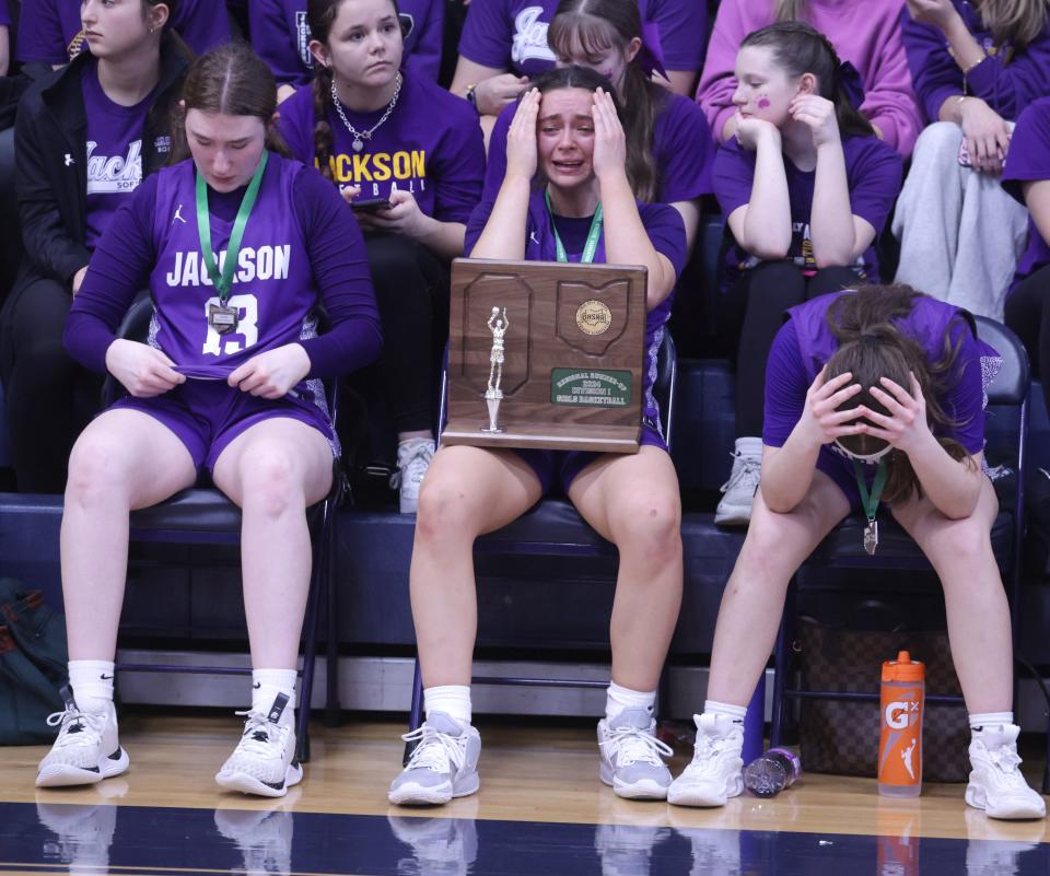 The Jackson Polar Bears Sarah Herron, left, Ashley Lahmers, middle, and Ashley Helle react to losing their Div. I Regional final game to Olmsted Falls at Sandusky High School Saturday, March, 9, 2024.