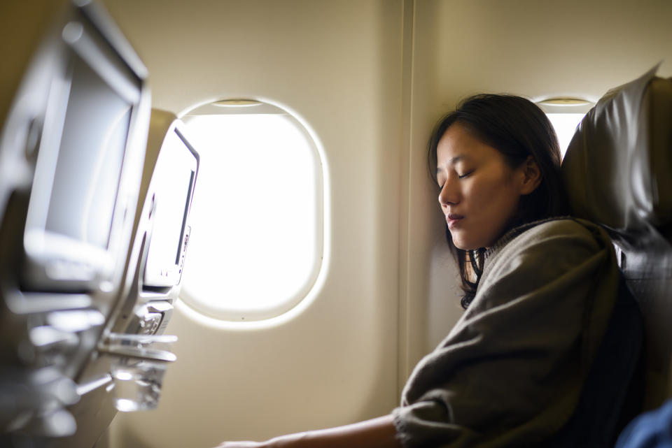 person sleeping on a flight