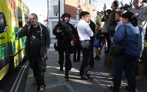 Armed British police officers stand on duty outside Parsons Green - Credit: DANIEL LEAL-OLIVAS/AFP