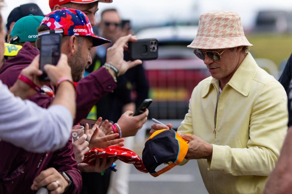 northampton, england july 7 actor brad pitt signs autographs for fans outside the paddock during the f1 grand prix of great britain at silverstone circuit on july 7, 2024 in northampton, united kingdom photo by kym illmangetty images