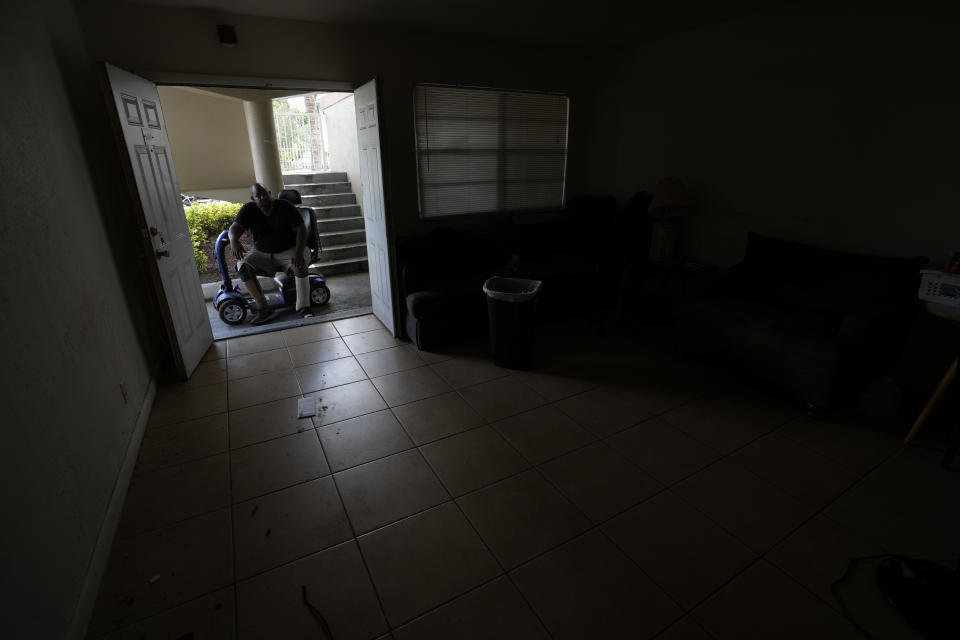 Freddie Davis, whose landlord raised his rent by 60 percent in the same month he lost his job as a truck driver, takes a last look as his empty apartment after a friend helped him move his belongings to a storage unit, following his final eviction notice Wednesday, Sept. 29, 2021, in Miami. (AP Photo/Rebecca Blackwell)