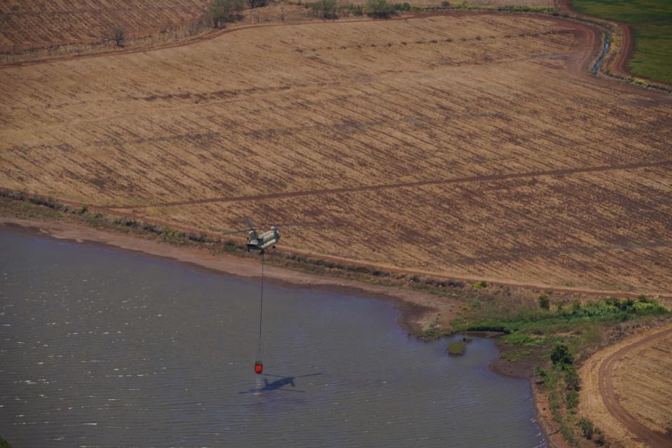 Two Hawaii Army National Guard CH47 Chinook perform aerial water bucket drops on the Island of Maui to assist the fight of wildfires, Maui, Hawaii, August 09, 2023. The two air crews performed 58 total bucket drops in 5 hours in up country Maui totaling over one hundred thousand gallons dropped on the fires. (U.S. National Guard Video by Air Force Master Sgt. Andrew Jackson)