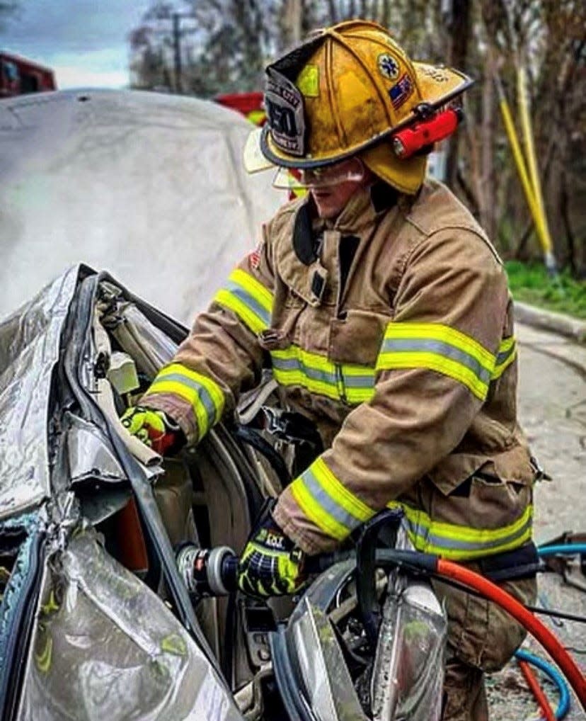 Traverse City firefighter/paramedic Jacob Steichen takes part in a training mission involving a simulated rollover crash in Traverse City in April 2020.