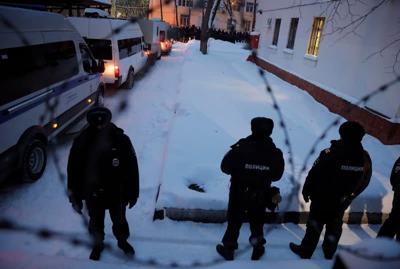 Police officers stand outside a police station where detained Russian opposition leader Navalny is being held, in Khimki