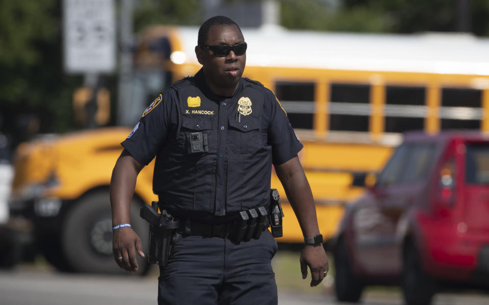 <p>Galveston Police officer Xavier Hancock works at the scene of a shooting at Santa Fe High School on Friday, May 18, 2018, in Santa Fe, Texas. (Photo: Stuart Villanueva /The Galveston County Daily News via AP) </p>