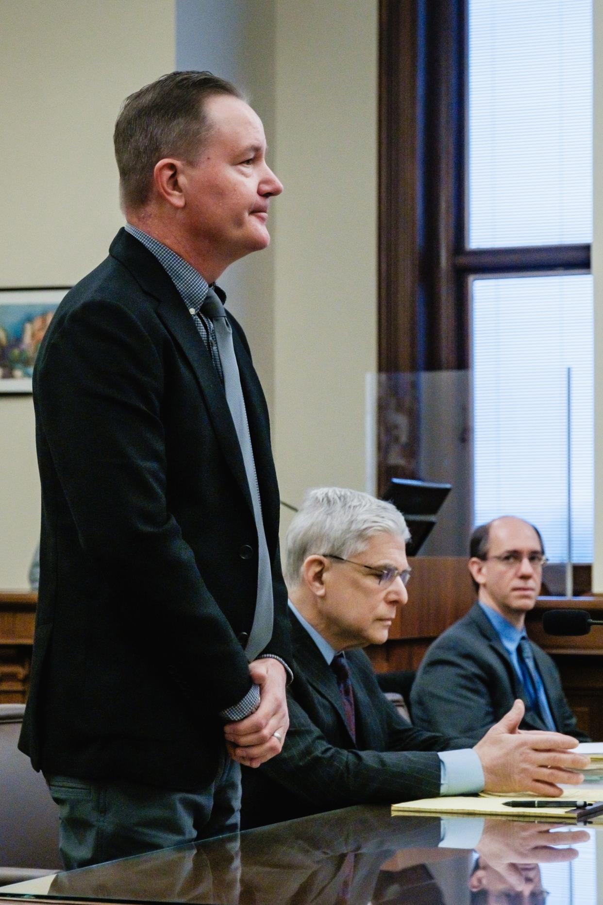 William Timberlake addresses the court during his sentencing hearing on the charge of attempted telecommunications fraud, before Judge Michael Ernest in the Tuscarawas County Court of Common Pleas. Pictured at center is defense attorney Peter T. Cahoon, and at right is special prosecutor Thomas Anger, representing the Ohio Auditor of State.