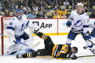 Pittsburgh Penguins' Evan Rodrigues (9) is checked to the ice by Tampa Bay Lightning's Ross Colton (79) in front of goalie Andrei Vasilevskiy (88) during the second period of an NHL hockey game in Pittsburgh, Tuesday, Oct. 26, 2021. (AP Photo/Gene J. Puskar)