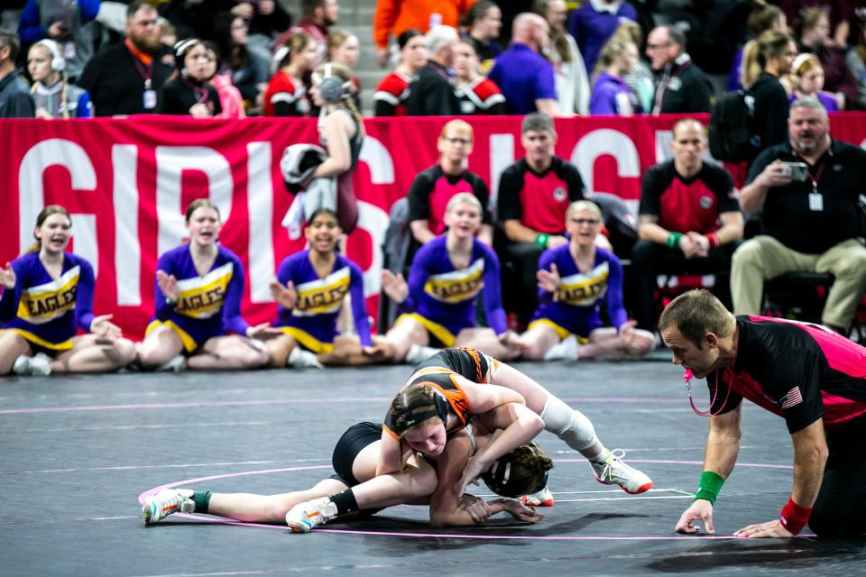 Solon's McKenna Rogers, top, wrestles Eagle Grove's Evelyn Jergenson at 105 pounds during the IGHSAU state girls wrestling tournament.
