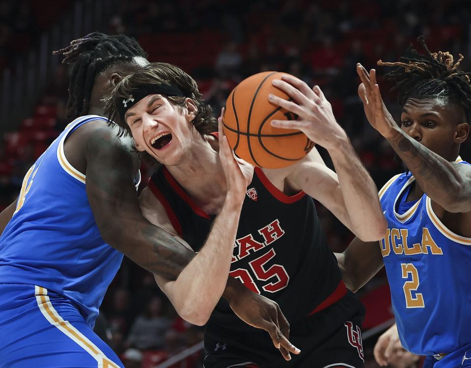 Utah Utes center Branden Carlson (35) drives through UCLA Bruins forward Kenneth Nwuba (14) and Dylan Andrews (2) at the University of Utah’s Huntsman Center in Salt Lake City on Thursday, Jan. 11, 2024. | Laura Seitz, Deseret News