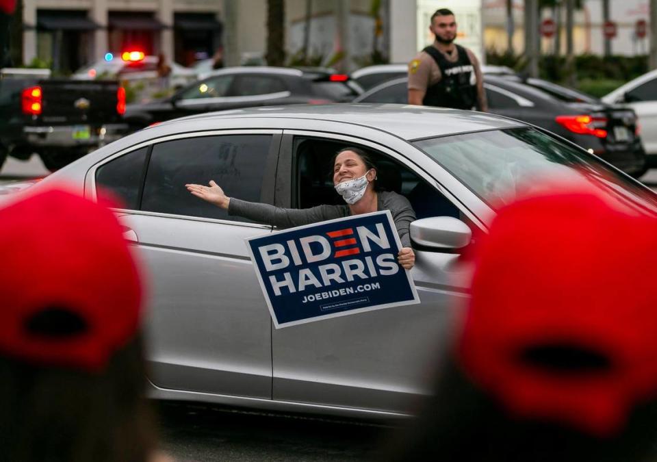 A Joe Biden supporter reacts to a Donald Trump rally outside of La Carreta in MiamiÕs Olympia Heights neighborhood on Saturday, November 7, 2020. A large crowd of Trump supporters arrived to the rally after former vice-president Joe Biden won the presidential election against Trump.