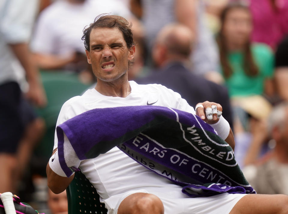 Rafael Nadal (pictured) grimacing in pain at the change of ends at Wimbledon.